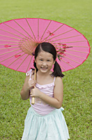 Girl using pink traditional Chinese paper umbrella - Asia Images Group