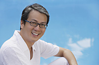 Man in white shirt smiling at camera - Asia Images Group