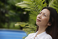 Woman outdoors, looking away, head shot - Asia Images Group