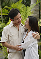 Couple embracing, outdoors - Asia Images Group