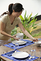 Woman setting the table - Asia Images Group