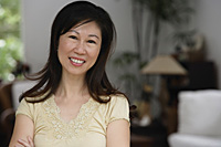 Woman at home, smiling at camera, head shot - Asia Images Group