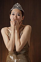 woman wearing crown, excited, winner, hands over mouth - Asia Images Group