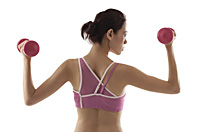 Woman with back to camera, lifting weights, profile of face - Asia Images Group