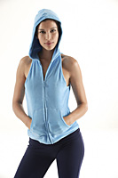 Woman looking at camera, hands in pocket of hooded vest - Asia Images Group