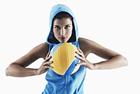 Woman holding volleyball, looking at camera - Asia Images Group