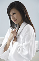 woman wearing bathrobe, thinking, relaxed - Asia Images Group