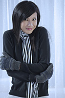 woman bundled up in scarf and mittens, cold, smiling - Asia Images Group