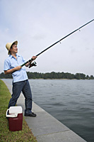 Man fishing with fishing pole - Asia Images Group
