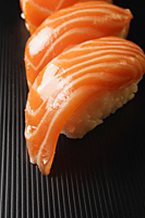 three pieces of salmon sushi, nigiri on rice ball - Asia Images Group
