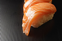 two pieces of salmon sushi, nigiri on rice ball - Asia Images Group