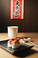 2 pieces of sushi, Kanikama Nigiri, crabstick on tray, "for sale", sale sign - Asia Images Group