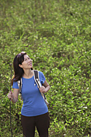 Woman hiking outdoors, nature, looking up to sky - Asia Images Group
