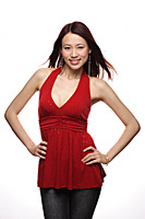 Young woman smiling at camera, hands on hip - Asia Images Group