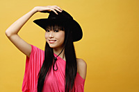 Young woman wearing black cowboy hat - Asia Images Group