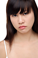 Young woman frowning, portrait - Asia Images Group