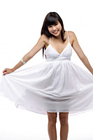 Young girl wearing white dress, smiling - Asia Images Group