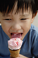 Young boy eating an ice cream cone - Asia Images Group