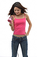 Young woman wearing pink top and blow drying hair - Asia Images Group