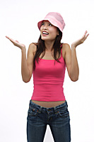Young woman wearing pink hat with arms raised up - Asia Images Group