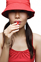 Girl in red blowing whistle - Asia Images Group