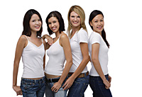 Four young women wearing white shirts and jeans, smiling at camera - Asia Images Group