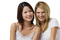 Two young woman wearing white shirts and smiling at camera - Asia Images Group