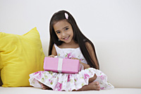 A young girl with a birthday present - Asia Images Group