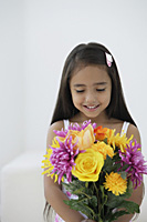 A young girl with a bunch of flowers - Asia Images Group