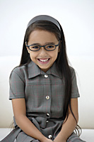 A young girl dressed in school uniform with glasses - Asia Images Group