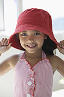 A young girl with a red hat - Asia Images Group