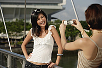 Friends take photos of each other on a bridge - Asia Images Group