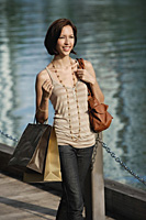 A woman with lots of shopping bags - Asia Images Group