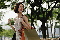 A woman with lots of shopping bags - Asia Images Group
