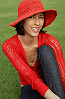 A woman relaxes on grass - Asia Images Group