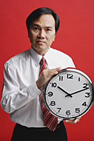 A man holds a clock - Asia Images Group