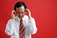 A man with a headache - Asia Images Group