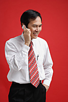 A man smiles as he talks on a cellphone - Asia Images Group