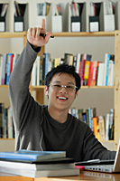 A young man studies in the library - Asia Images Group