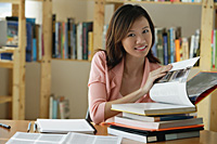 A young woman studies in the library - Asia Images Group