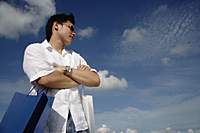 A young man with shopping bags - Asia Images Group