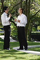 Two men eat their lunch together in the park - Asia Images Group