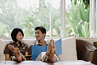 A young couple read together - Asia Images Group