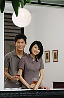 A young couple smile at the camera together - Asia Images Group