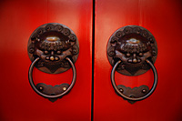 Pair of brass lion head door knockers at temple - Asia Images Group