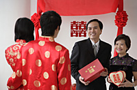 A newlywed couple are given gifts - Asia Images Group