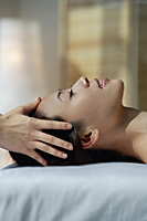 A woman has a relaxing massage - Asia Images Group