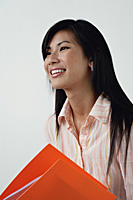 A woman with an orange folder - Asia Images Group