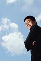A man in a suit smiles at the camera - Asia Images Group