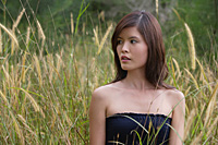 Woman standing in long grass - Asia Images Group